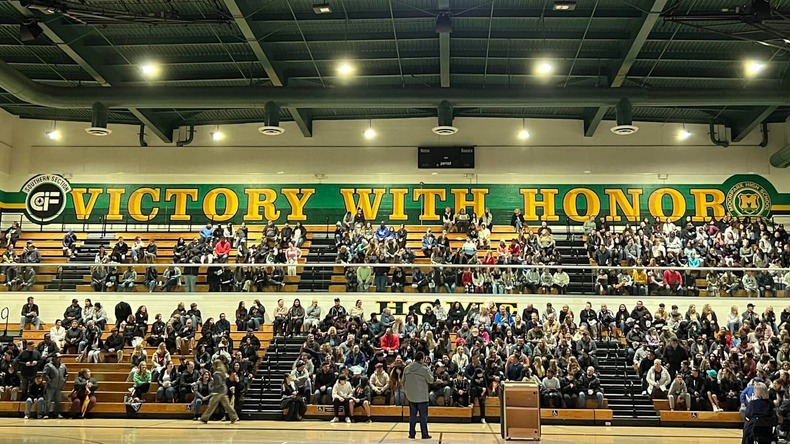 A packed Moorpark High School gym rally under the Victory With Honor banner